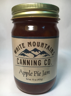 A jar of apple pie jam on top of a table.