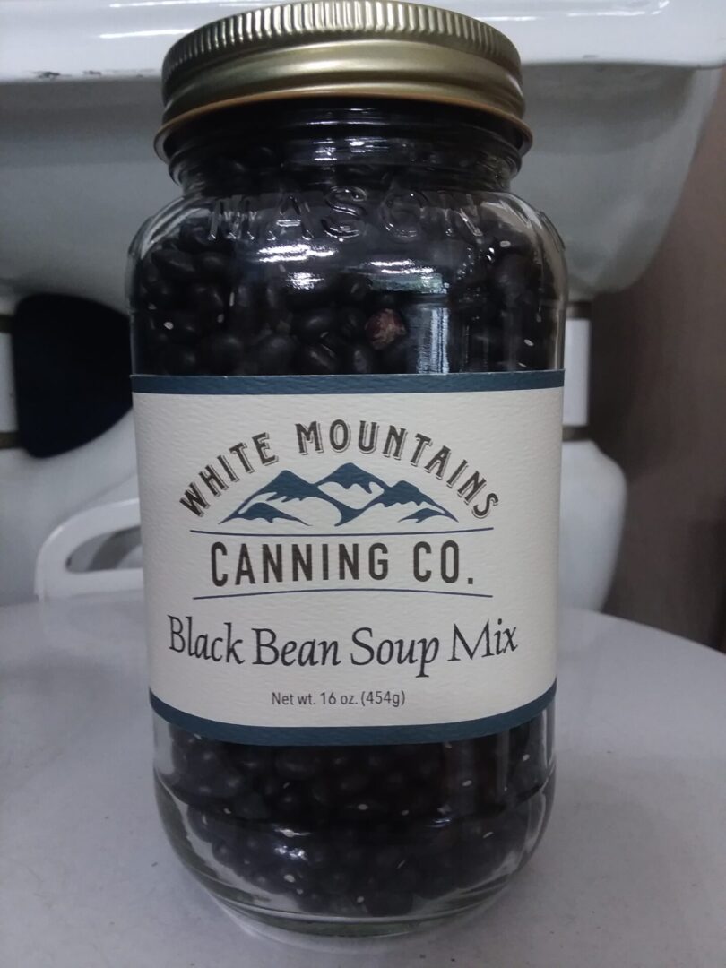 A jar of black bean soup mix on top of a table.