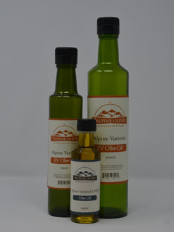 Three bottles of olive oil are shown with a small bottle.