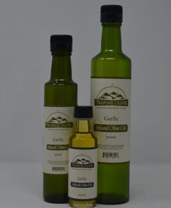 Three bottles of garlic oil are shown with a bottle labeled, alpine olive.