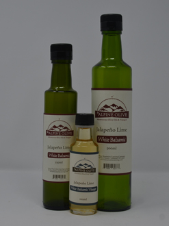 Three bottles of lime juice are shown with one bottle in the middle.