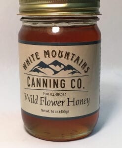 A jar of honey is shown with the label.