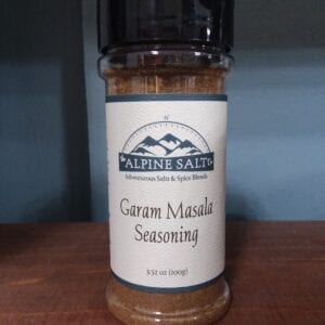 A bottle of garam masala seasoning on top of a table.