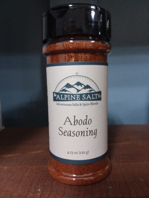 A bottle of seasoning sitting on top of a table.