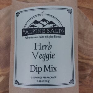 A bag of herb veggie dip mix on top of a wooden table.