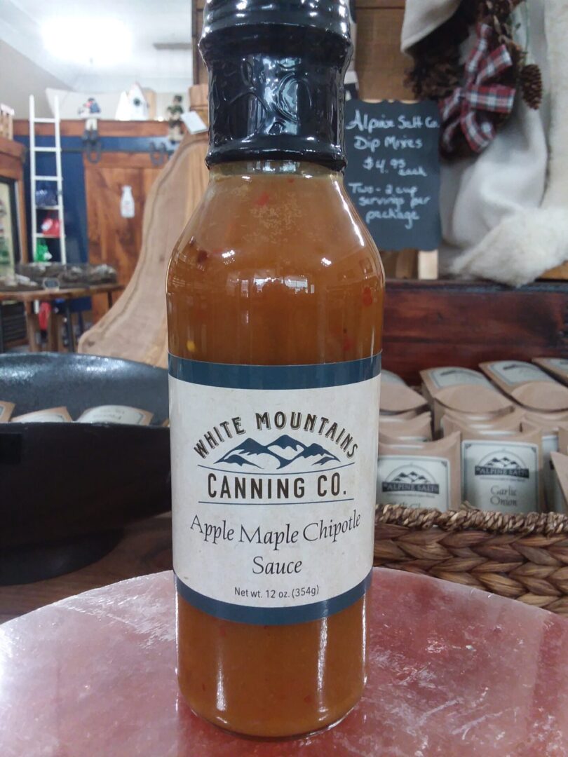 A bottle of apple maple chipotle sauce on display.
