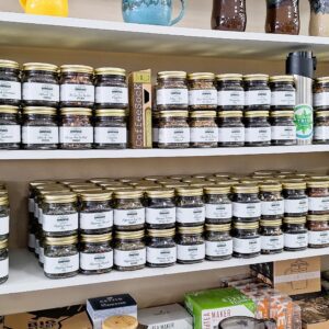 Jars of tea and coffee on shelves.
