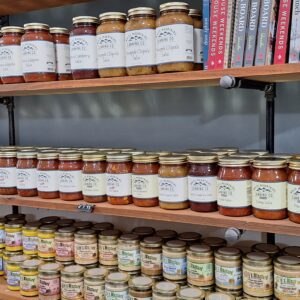 Jars of sauces and spreads on shelves.