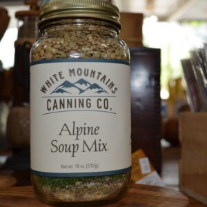 A jar of alpine soup mix on top of a table.