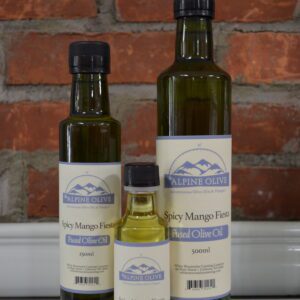 Three bottles of olive oil on a ledge.