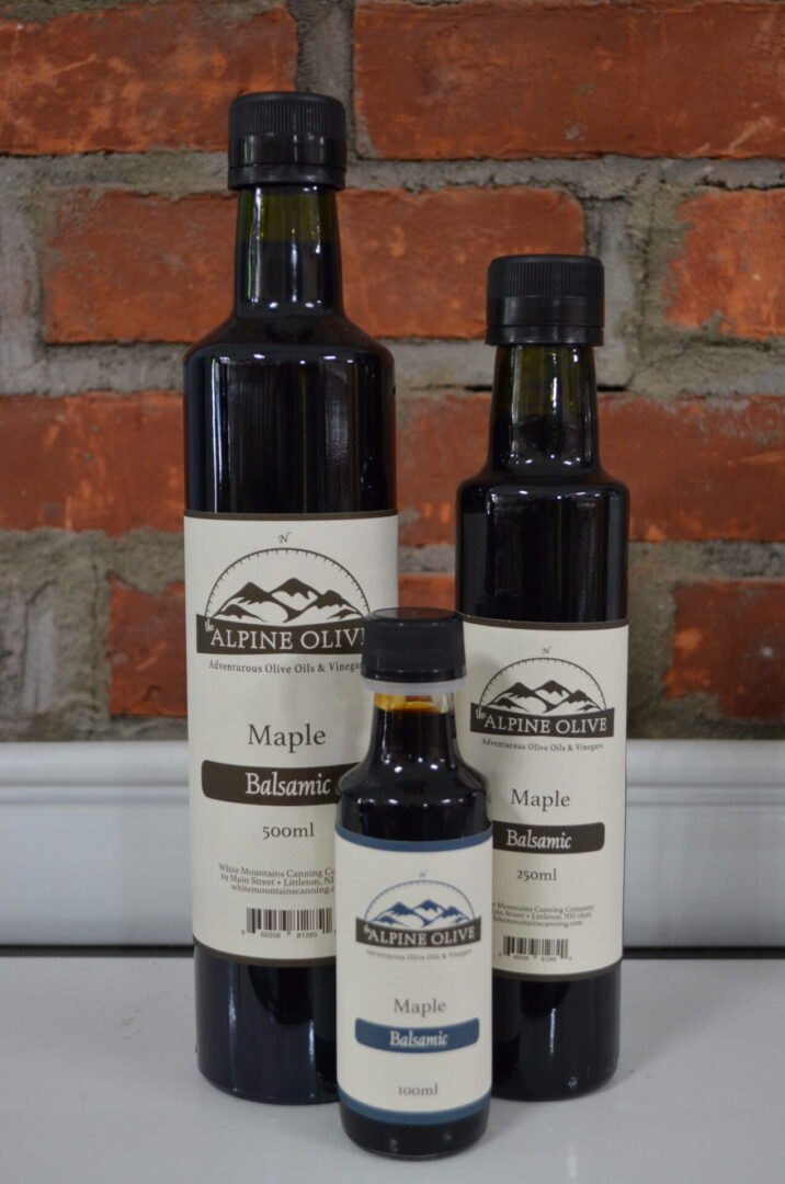 Three bottles of maple balsamic vinegar and a bottle.
