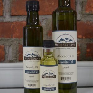 Three bottles of olive oil on a counter.