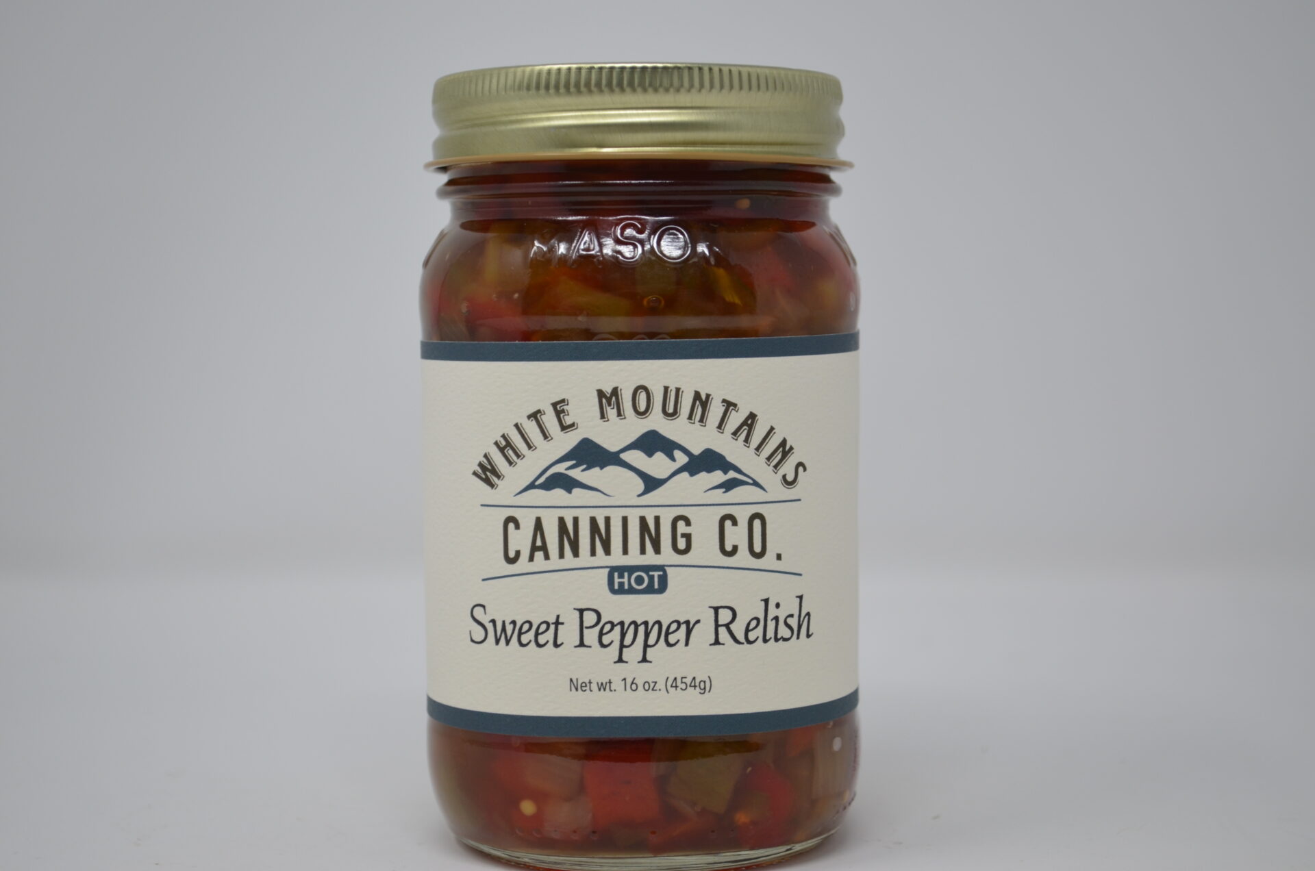 A jar of sweet pepper relish on top of a table.