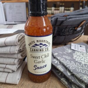 Sweet chili garlic sauce on display table.